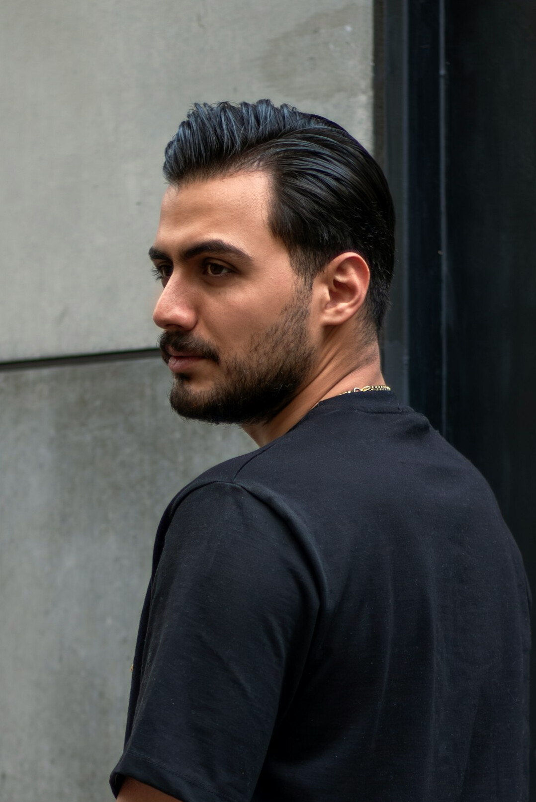 Portrait of a man with short dark hair and a beard